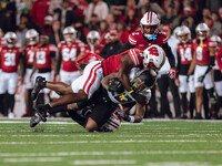 Oregon running back Jordan James #20 is taken down by Wisconsin Badgers outside linebacker Leon Lowery Jr. #8 and Wisconsin Badgers safety P...