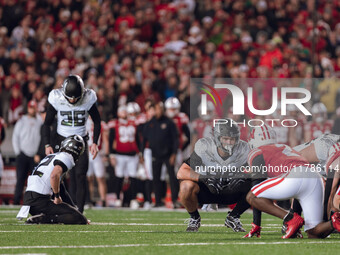 Oregon tight end Patrick Herbert #88 stares down Wisconsin Badgers cornerback Ricardo Hallman #2 before Oregon kicker Atticus Sappington #36...