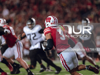 Wisconsin Badgers cornerback Nyzier Fourqurean #3 runs down the field after intercepting a pass against the Oregon Ducks at Camp Randall Sta...