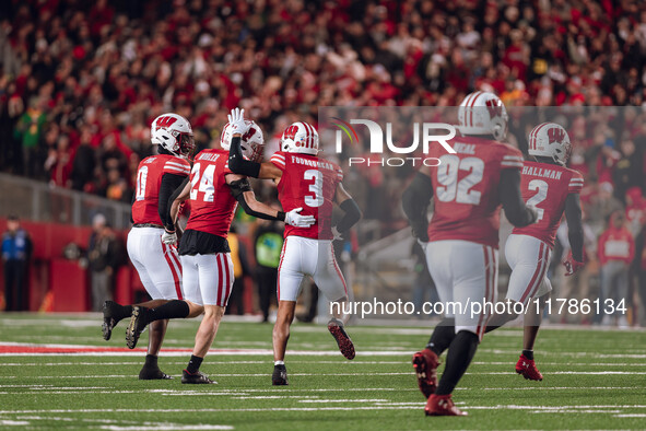 Wisconsin Badgers safety Hunter Wohler #24 and Wisconsin Badgers cornerback Nyzier Fourqurean #3 celebrate an interception against The Orego...