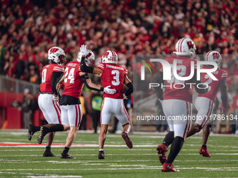 Wisconsin Badgers safety Hunter Wohler #24 and Wisconsin Badgers cornerback Nyzier Fourqurean #3 celebrate an interception against The Orego...