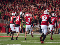 Wisconsin Badgers safety Hunter Wohler #24 and Wisconsin Badgers cornerback Nyzier Fourqurean #3 celebrate an interception against The Orego...