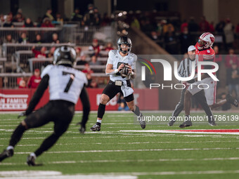 Oregon quarterback Dillon Gabriel #8 looks downfield to Oregon wide receiver Evan Stewart #7 while being pursued by Wisconsin Badgers outsid...