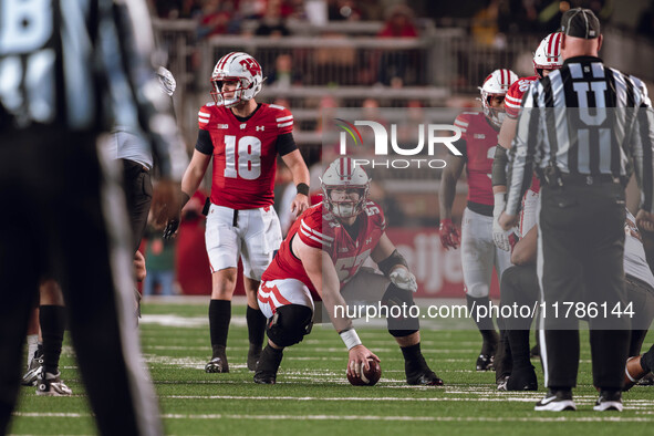 Wisconsin Badgers quarterback Braedyn Locke #18 and Wisconsin Badgers offensive lineman Jake Renfro #57 read the Oregon defense before the s...