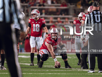 Wisconsin Badgers quarterback Braedyn Locke #18 and Wisconsin Badgers offensive lineman Jake Renfro #57 read the Oregon defense before the s...