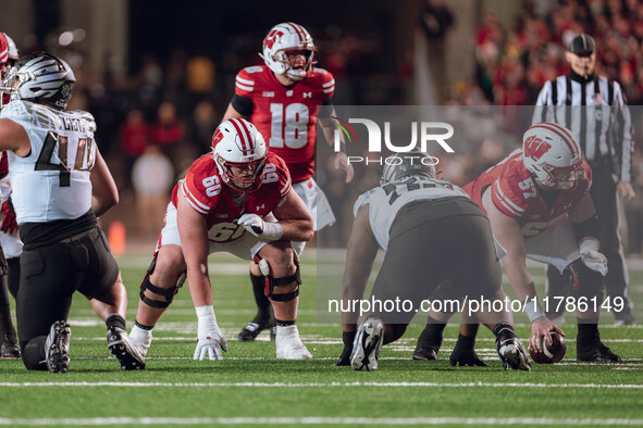 Wisconsin Badgers offensive lineman Joe Huber #60 and Wisconsin Badgers offensive lineman Jake Renfro #57 take their stance prior to the sna...