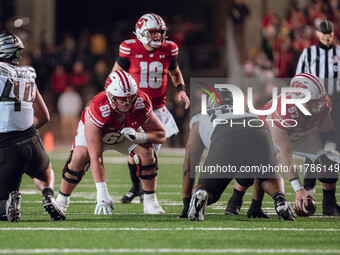 Wisconsin Badgers offensive lineman Joe Huber #60 and Wisconsin Badgers offensive lineman Jake Renfro #57 take their stance prior to the sna...