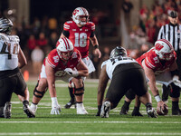 Wisconsin Badgers offensive lineman Joe Huber #60 and Wisconsin Badgers offensive lineman Jake Renfro #57 take their stance prior to the sna...