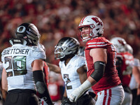 Wisconsin Badgers offensive lineman Jack Nelson #79 gives Oregon inside linebacker Bryce Boettcher #28 a smirk after a play at Camp Randall...