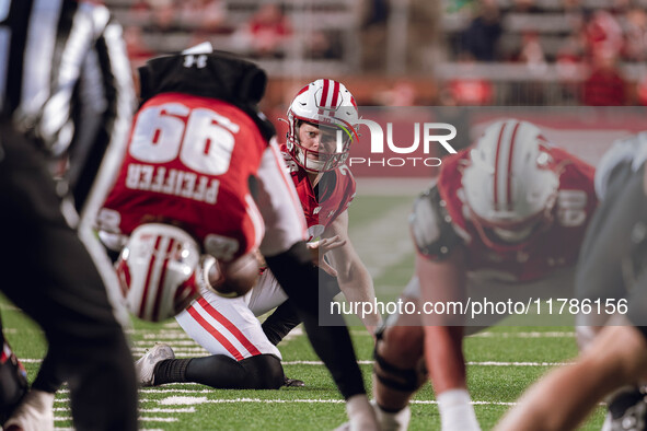 Wisconsin Badgers punter Gavin Meyers #28 prepares to hold a kick against the Oregon Ducks at Camp Randall Stadium in Madison, Wisconsin, on...