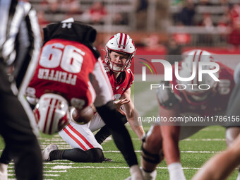 Wisconsin Badgers punter Gavin Meyers #28 prepares to hold a kick against the Oregon Ducks at Camp Randall Stadium in Madison, Wisconsin, on...