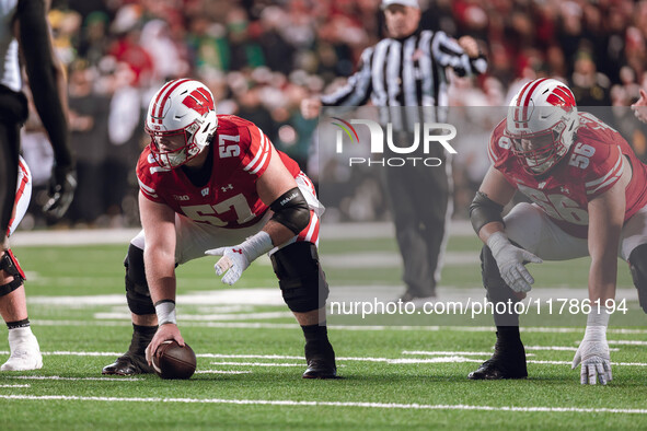 Wisconsin Badgers offensive lineman Jake Renfro #57 and Wisconsin Badgers offensive lineman Joe Brunner #56 get ready before the snap agains...