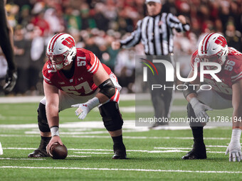 Wisconsin Badgers offensive lineman Jake Renfro #57 and Wisconsin Badgers offensive lineman Joe Brunner #56 get ready before the snap agains...