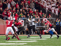 Oregon running back Jordan James #20 gives a stiff arm against the Wisconsin Badgers at Camp Randall Stadium in Madison, Wisconsin, on Novem...