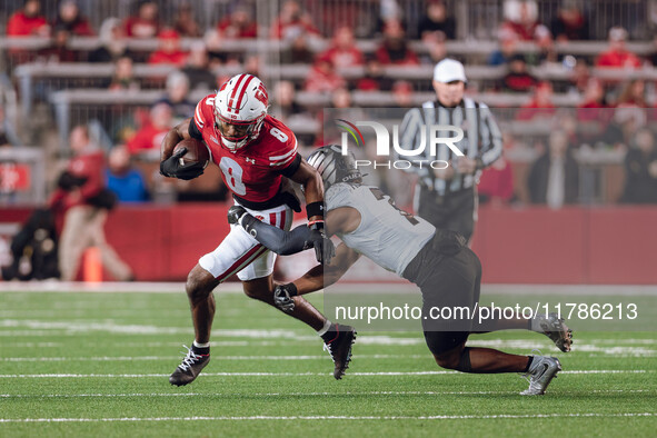 Wisconsin Badgers wide receiver Vinny Anthony II #8 tries to escape a tackle against the Oregon Ducks at Camp Randall Stadium in Madison, Wi...