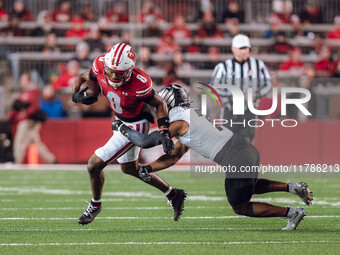 Wisconsin Badgers wide receiver Vinny Anthony II #8 tries to escape a tackle against the Oregon Ducks at Camp Randall Stadium in Madison, Wi...