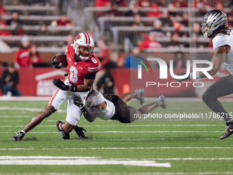 Wisconsin Badgers wide receiver Vinny Anthony II #8 tries to escape a tackle against the Oregon Ducks at Camp Randall Stadium in Madison, Wi...