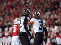 Oregon defensive back Brandon Johnson #3 and Oregon inside linebacker Jeffrey Bassa #2 celebrate after a defensive stop against the Wisconsi...