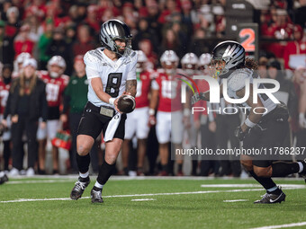 Oregon quarterback Dillon Gabriel #8 hands the ball off to Oregon running back Jordan James #20 against the Wisconsin Badgers at Camp Randal...