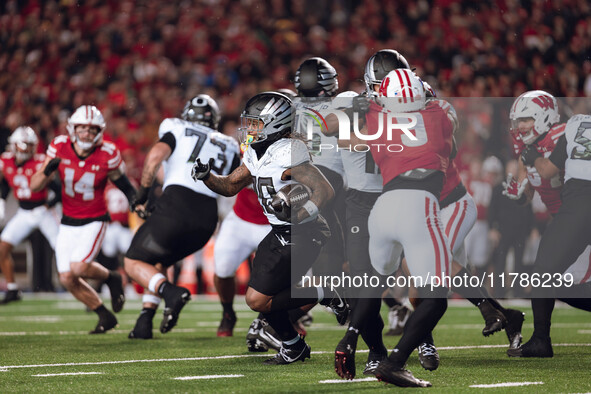 Oregon running back Jordan James #20 finds the hole against the Wisconsin Badgers defense at Camp Randall Stadium in Madison, Wisconsin, on...