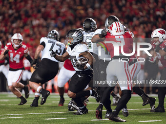 Oregon running back Jordan James #20 finds the hole against the Wisconsin Badgers defense at Camp Randall Stadium in Madison, Wisconsin, on...