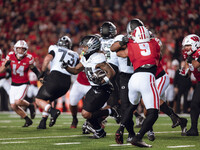 Oregon running back Jordan James #20 finds the hole against the Wisconsin Badgers defense at Camp Randall Stadium in Madison, Wisconsin, on...