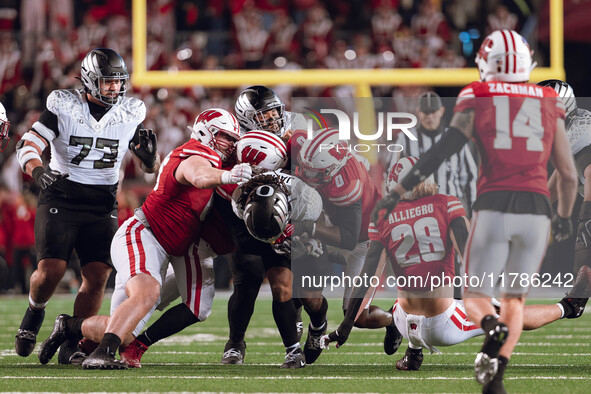 Oregon running back Jordan James #20 plows through the Wisconsin Badgers defense at Camp Randall Stadium in Madison, Wisconsin, on November...