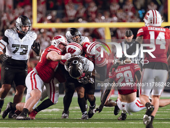 Oregon running back Jordan James #20 plows through the Wisconsin Badgers defense at Camp Randall Stadium in Madison, Wisconsin, on November...