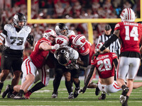 Oregon running back Jordan James #20 plows through the Wisconsin Badgers defense at Camp Randall Stadium in Madison, Wisconsin, on November...