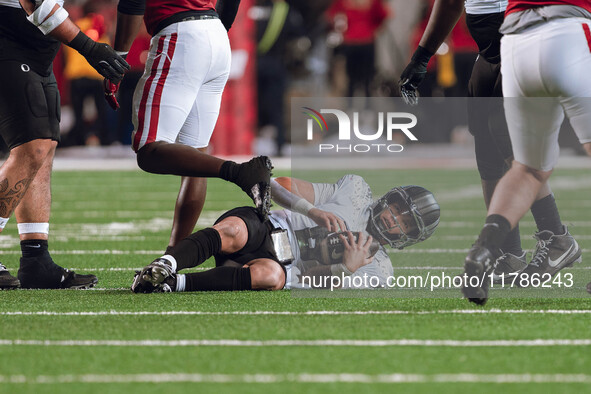 Oregon quarterback Dillon Gabriel #8 lies on the ground after being stopped by the Wisconsin Badgers defense at Camp Randall Stadium in Madi...