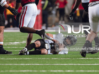 Oregon quarterback Dillon Gabriel #8 lies on the ground after being stopped by the Wisconsin Badgers defense at Camp Randall Stadium in Madi...