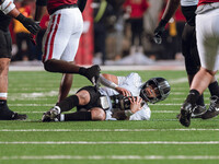 Oregon quarterback Dillon Gabriel #8 lies on the ground after being stopped by the Wisconsin Badgers defense at Camp Randall Stadium in Madi...