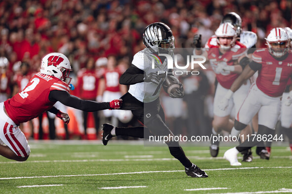 Oregon wide receiver Evan Stewart #7 escapes the clutches of Wisconsin Badgers cornerback Ricardo Hallman #2 at Camp Randall Stadium in Madi...