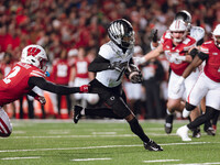 Oregon wide receiver Evan Stewart #7 escapes the clutches of Wisconsin Badgers cornerback Ricardo Hallman #2 at Camp Randall Stadium in Madi...