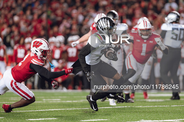 Oregon wide receiver Evan Stewart #7 escapes the clutches of Wisconsin Badgers cornerback Ricardo Hallman #2 at Camp Randall Stadium in Madi...