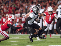 Oregon wide receiver Evan Stewart #7 escapes the clutches of Wisconsin Badgers cornerback Ricardo Hallman #2 at Camp Randall Stadium in Madi...