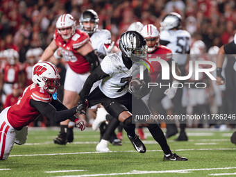 Oregon wide receiver Evan Stewart #7 escapes the clutches of Wisconsin Badgers cornerback Ricardo Hallman #2 at Camp Randall Stadium in Madi...