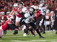 Oregon wide receiver Evan Stewart #7 escapes the clutches of Wisconsin Badgers cornerback Ricardo Hallman #2 at Camp Randall Stadium in Madi...