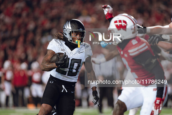 Oregon running back Jordan James #20 finds an opening on the edge for a touchdown against the Wisconsin Badgers at Camp Randall Stadium in M...