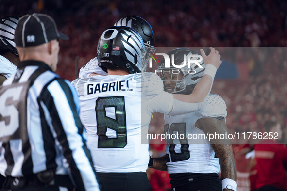 Oregon quarterback Dillon Gabriel #8 celebrates an Oregon running back Jordan James #20 touchdown against the Wisconsin Badgers at Camp Rand...