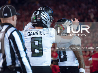 Oregon quarterback Dillon Gabriel #8 celebrates an Oregon running back Jordan James #20 touchdown against the Wisconsin Badgers at Camp Rand...