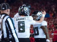 Oregon quarterback Dillon Gabriel #8 celebrates an Oregon running back Jordan James #20 touchdown against the Wisconsin Badgers at Camp Rand...