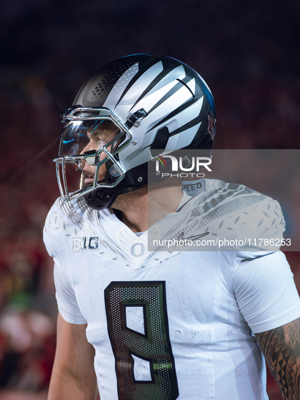 Oregon quarterback Dillon Gabriel #8 returns to the sideline after a touchdown against the Wisconsin Badgers at Camp Randall Stadium in Madi...