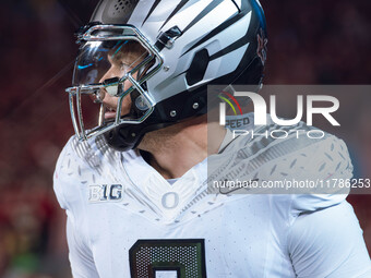 Oregon quarterback Dillon Gabriel #8 returns to the sideline after a touchdown against the Wisconsin Badgers at Camp Randall Stadium in Madi...