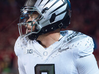 Oregon quarterback Dillon Gabriel #8 returns to the sideline after a touchdown against the Wisconsin Badgers at Camp Randall Stadium in Madi...