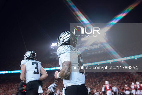 Oregon quarterback Dillon Gabriel #8 returns to the sideline after a touchdown against the Wisconsin Badgers at Camp Randall Stadium in Madi...