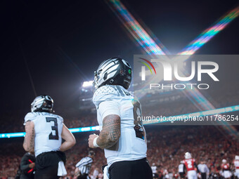 Oregon quarterback Dillon Gabriel #8 returns to the sideline after a touchdown against the Wisconsin Badgers at Camp Randall Stadium in Madi...