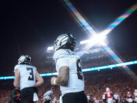 Oregon quarterback Dillon Gabriel #8 returns to the sideline after a touchdown against the Wisconsin Badgers at Camp Randall Stadium in Madi...