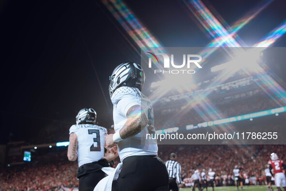 Oregon quarterback Dillon Gabriel #8 returns to the sideline after a touchdown against the Wisconsin Badgers at Camp Randall Stadium in Madi...