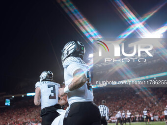 Oregon quarterback Dillon Gabriel #8 returns to the sideline after a touchdown against the Wisconsin Badgers at Camp Randall Stadium in Madi...